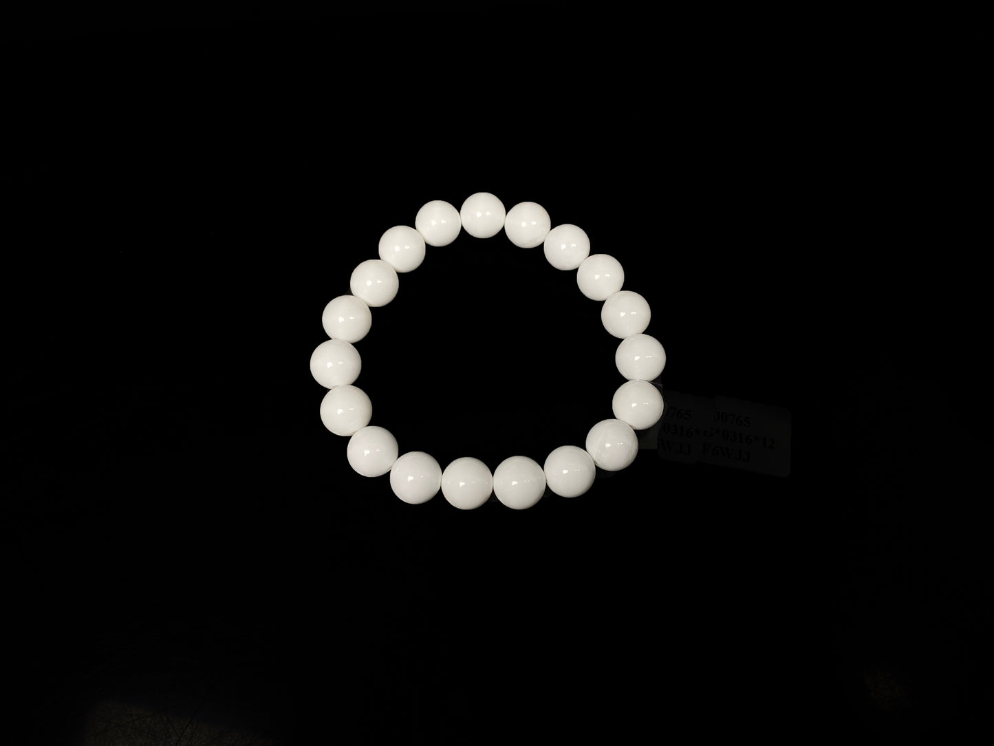 A porcelain white smooth bead ceramic beaded bracelet.