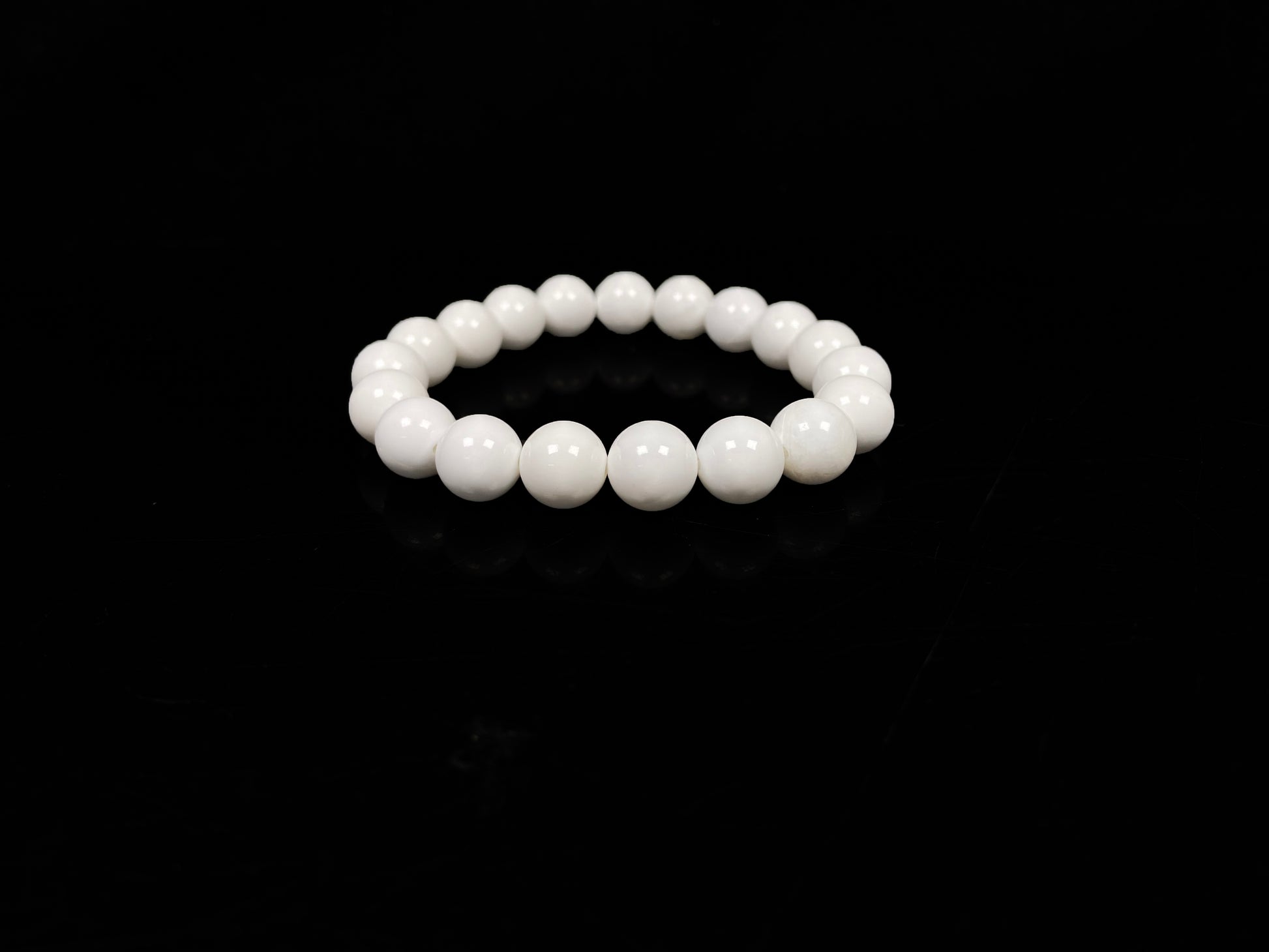 A porcelain white smooth bead ceramic beaded bracelet.