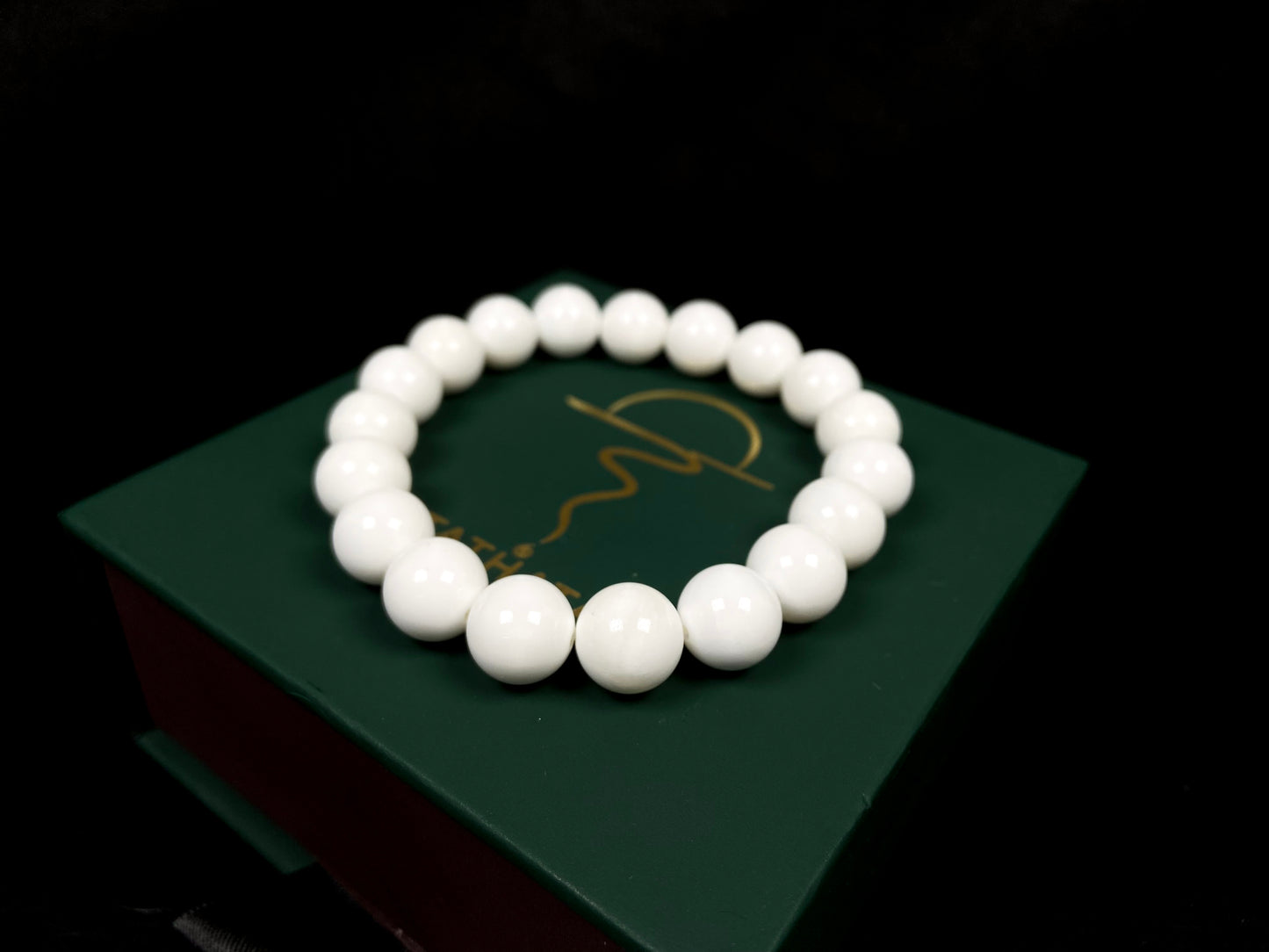 A porcelain white smooth bead ceramic beaded bracelet.