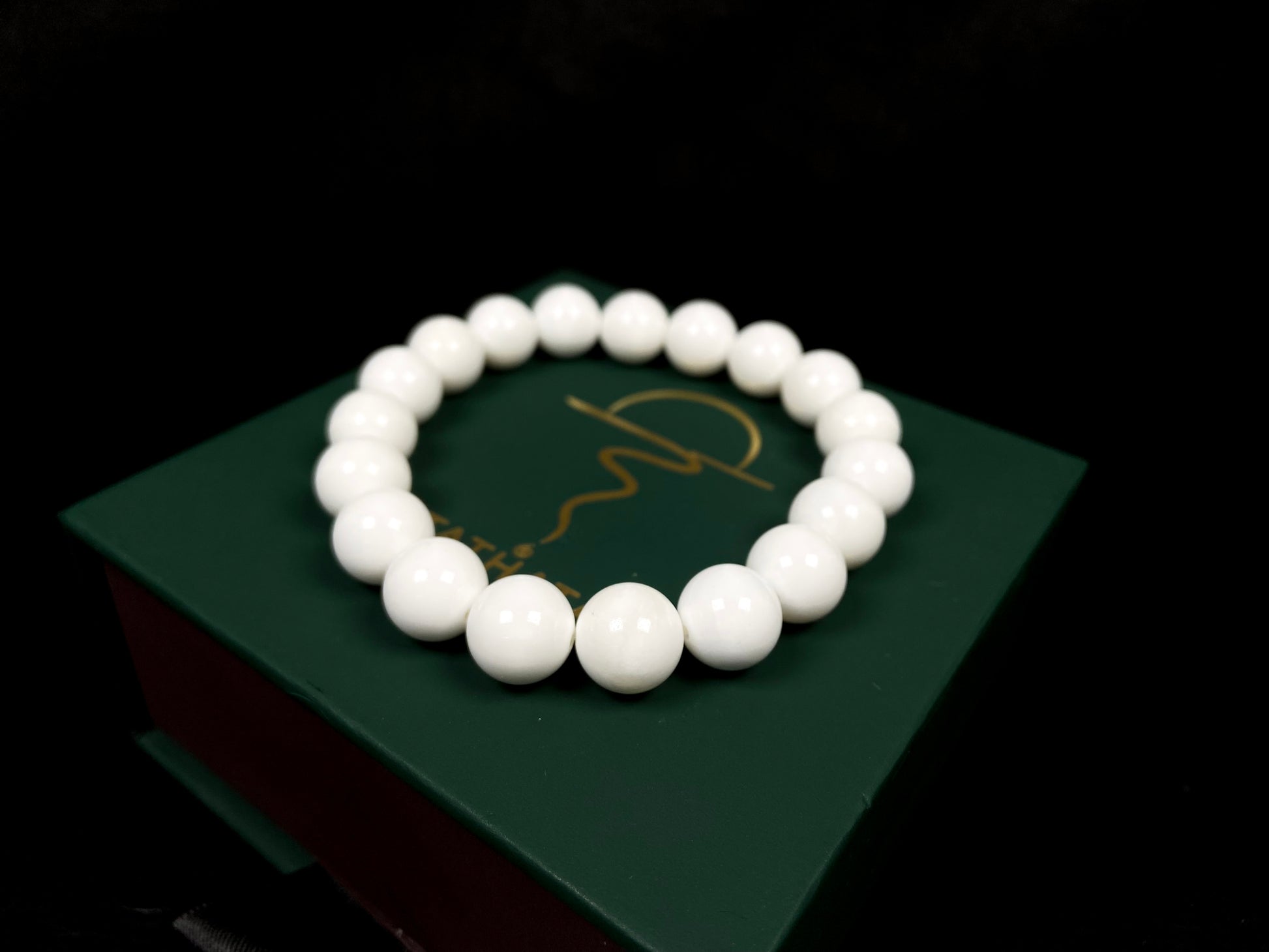 A porcelain white smooth bead ceramic beaded bracelet.