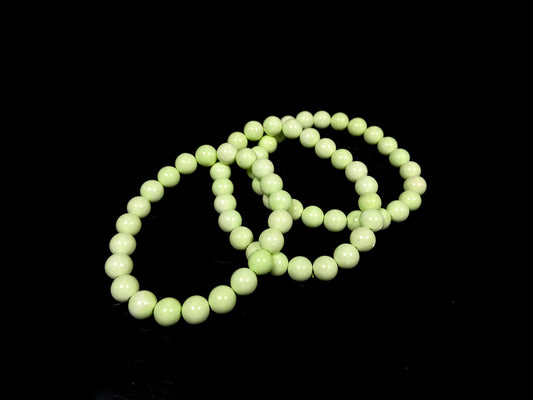A turquoise green smooth bead ceramic beaded bracelet.