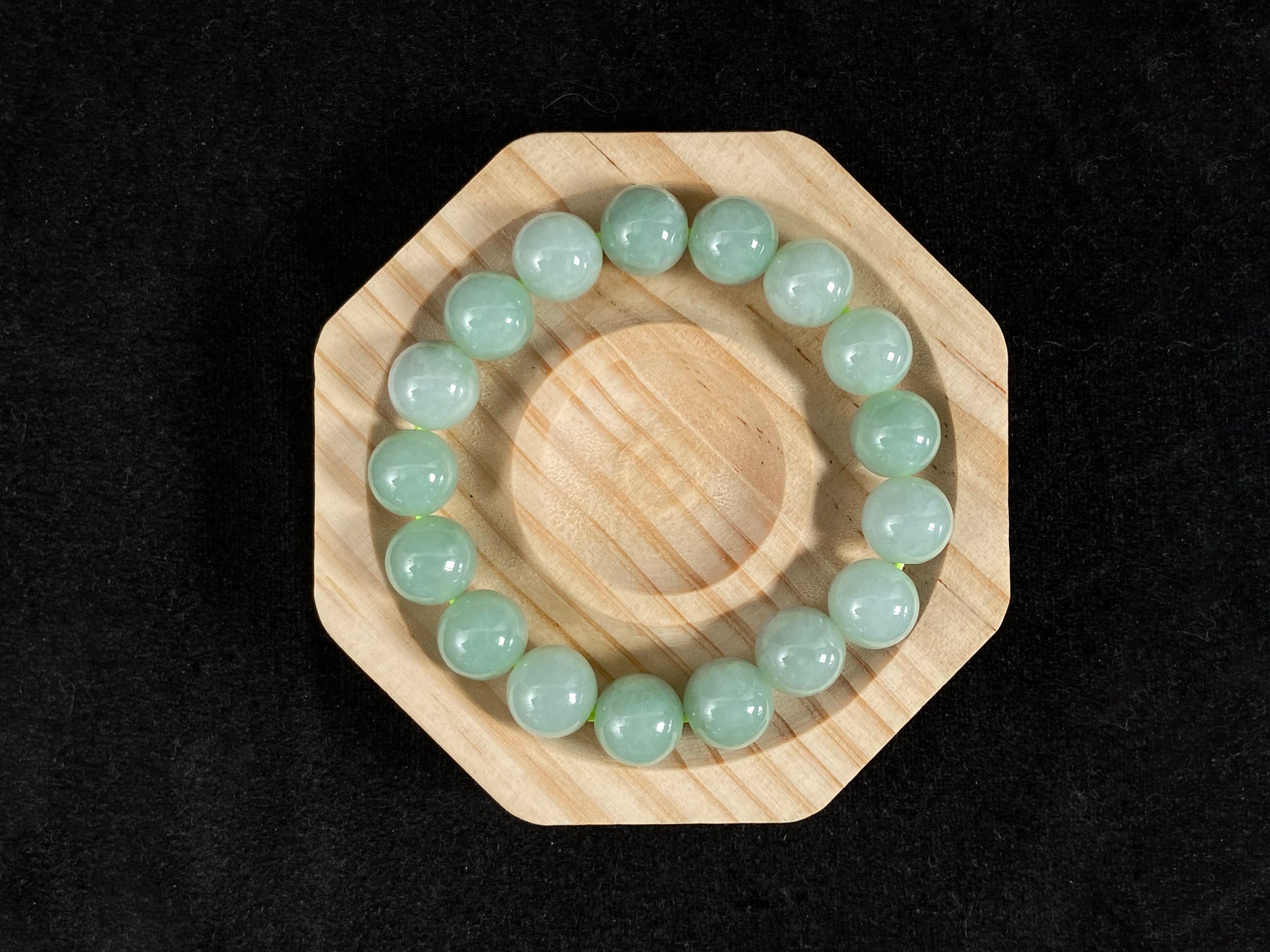 A jade bead strand in a soft green hue.