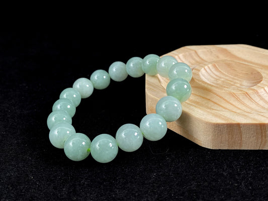 A jade bead strand in a soft green hue.
