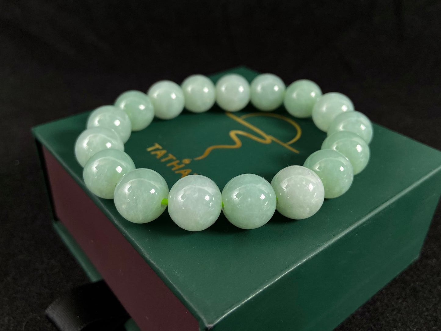 A jade bead strand in a soft green hue.