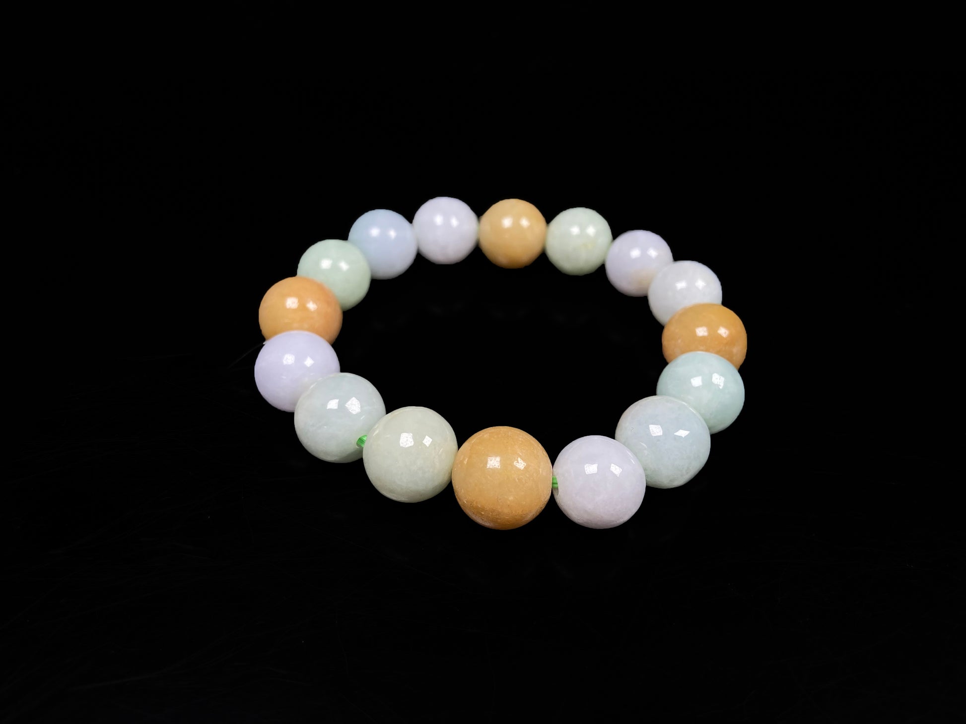 A tri-color green yellow purple jadeite beads bracelet.