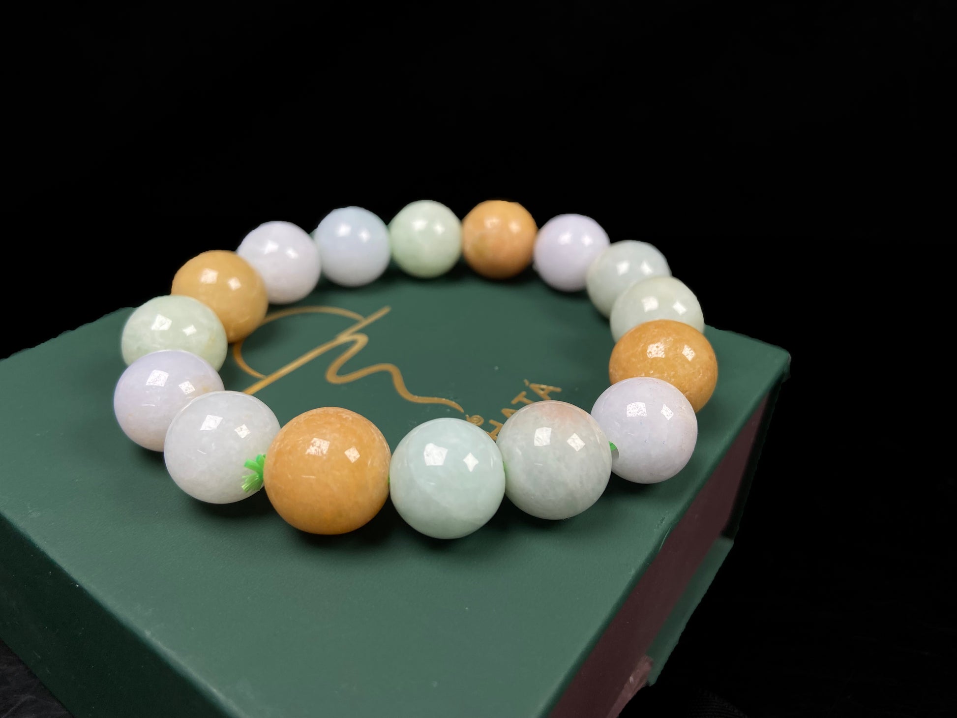 A tri-color green yellow purple jadeite beads bracelet.