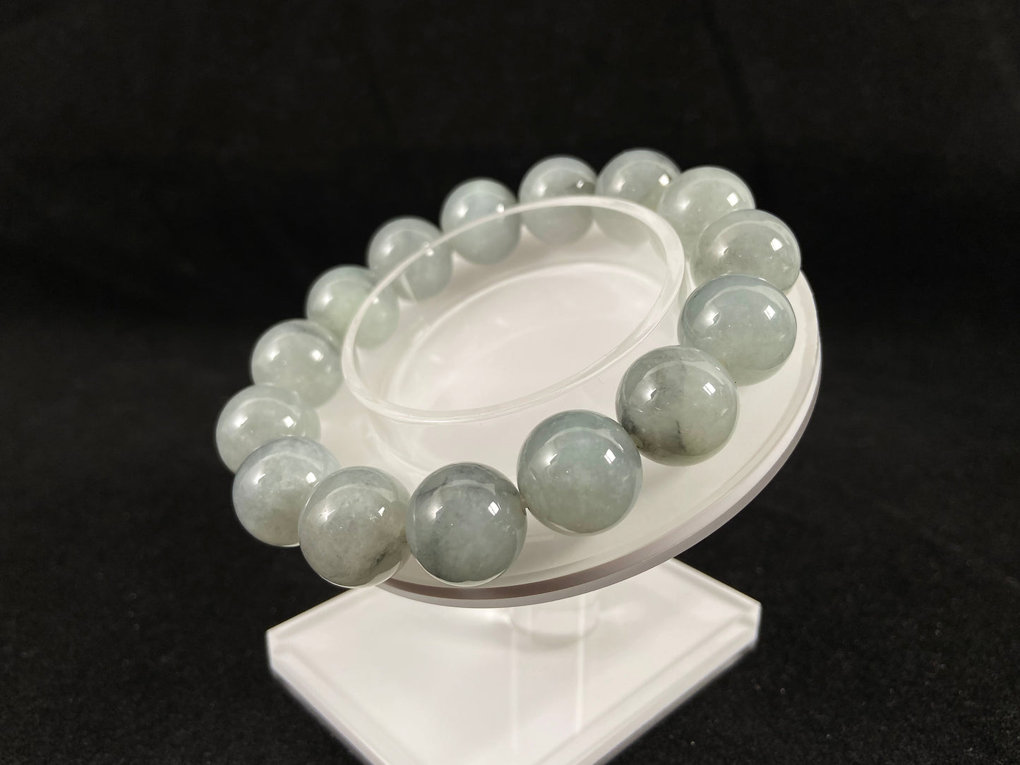 A strand of semi transparent grayish white jade beads.