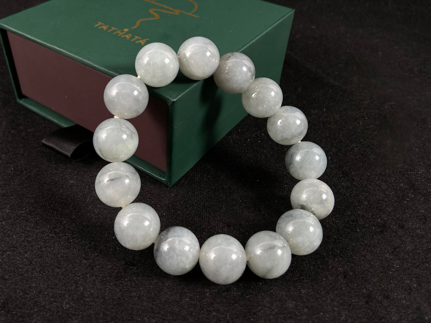 A strand of semi transparent grayish white jade beads.