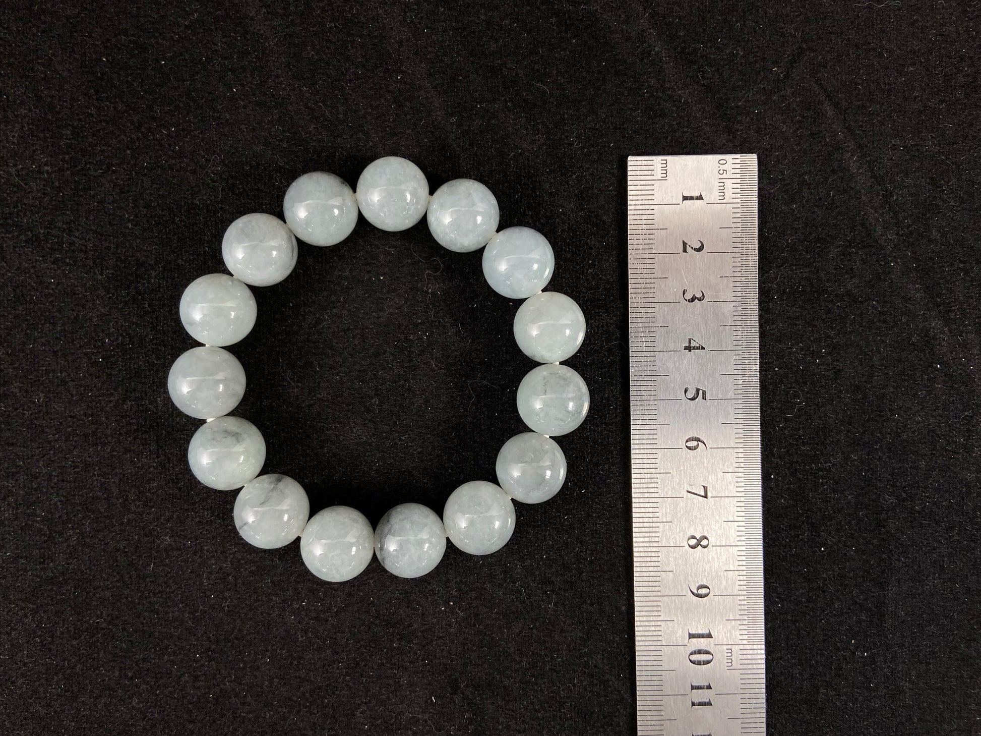 A strand of semi transparent grayish white jade beads.