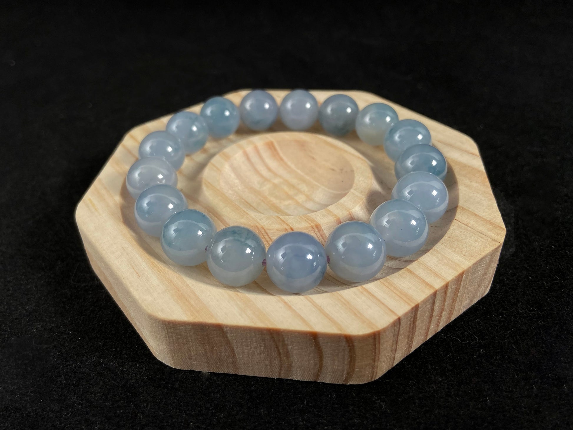 A translucent icy jade bead strand in sky blue tones with floating blue floral inclusions.