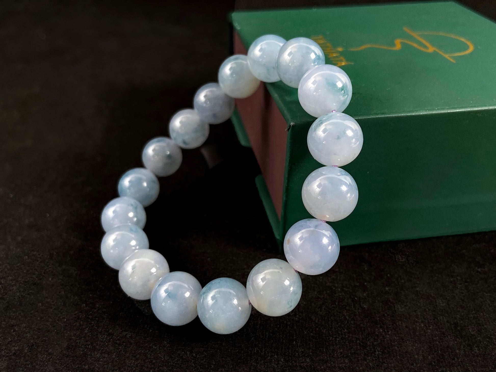 A translucent icy jade bead strand in sky blue tones with floating blue floral inclusions.