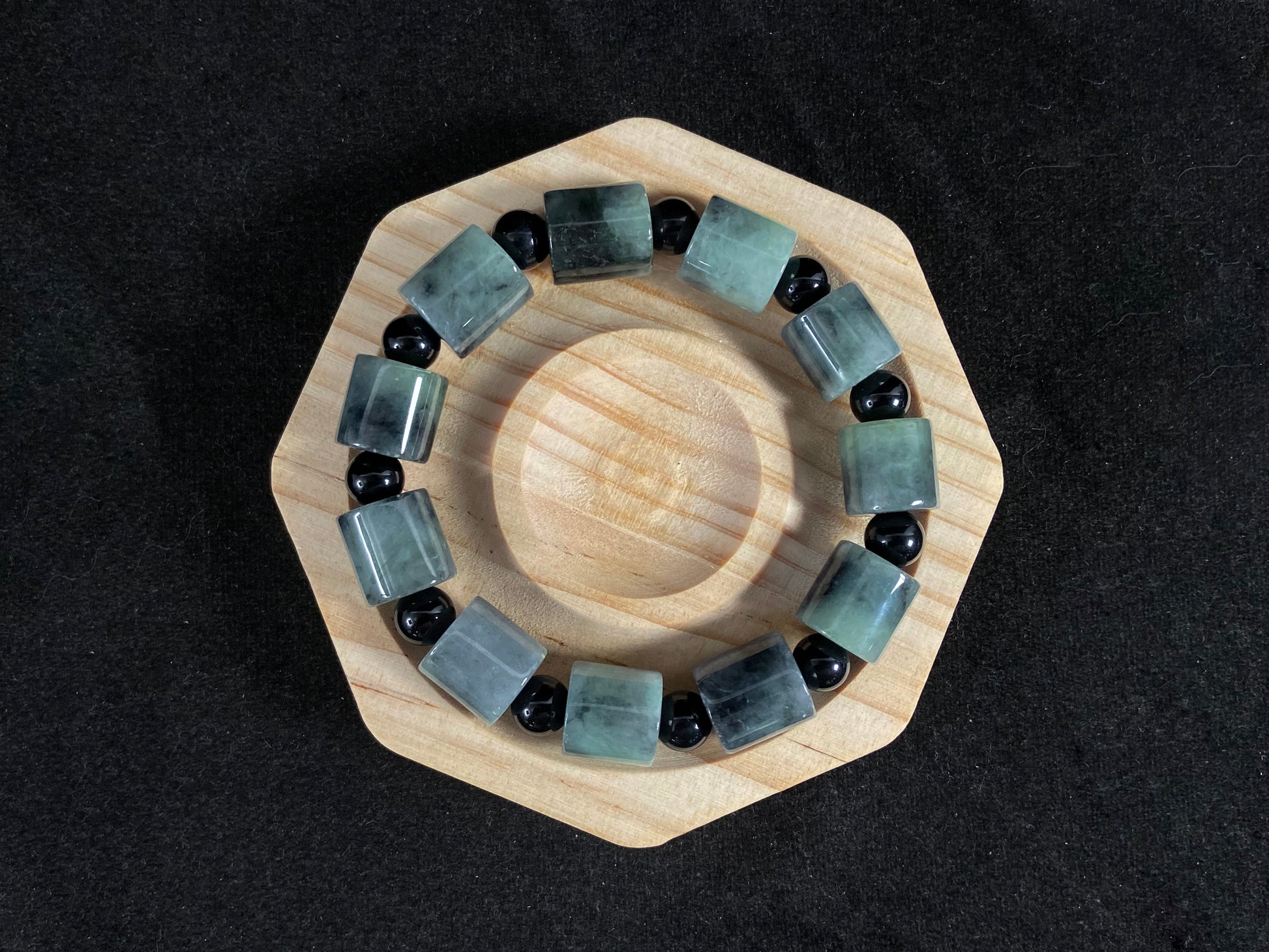 Two black beads combined with a white green black gradient cylinder bead.