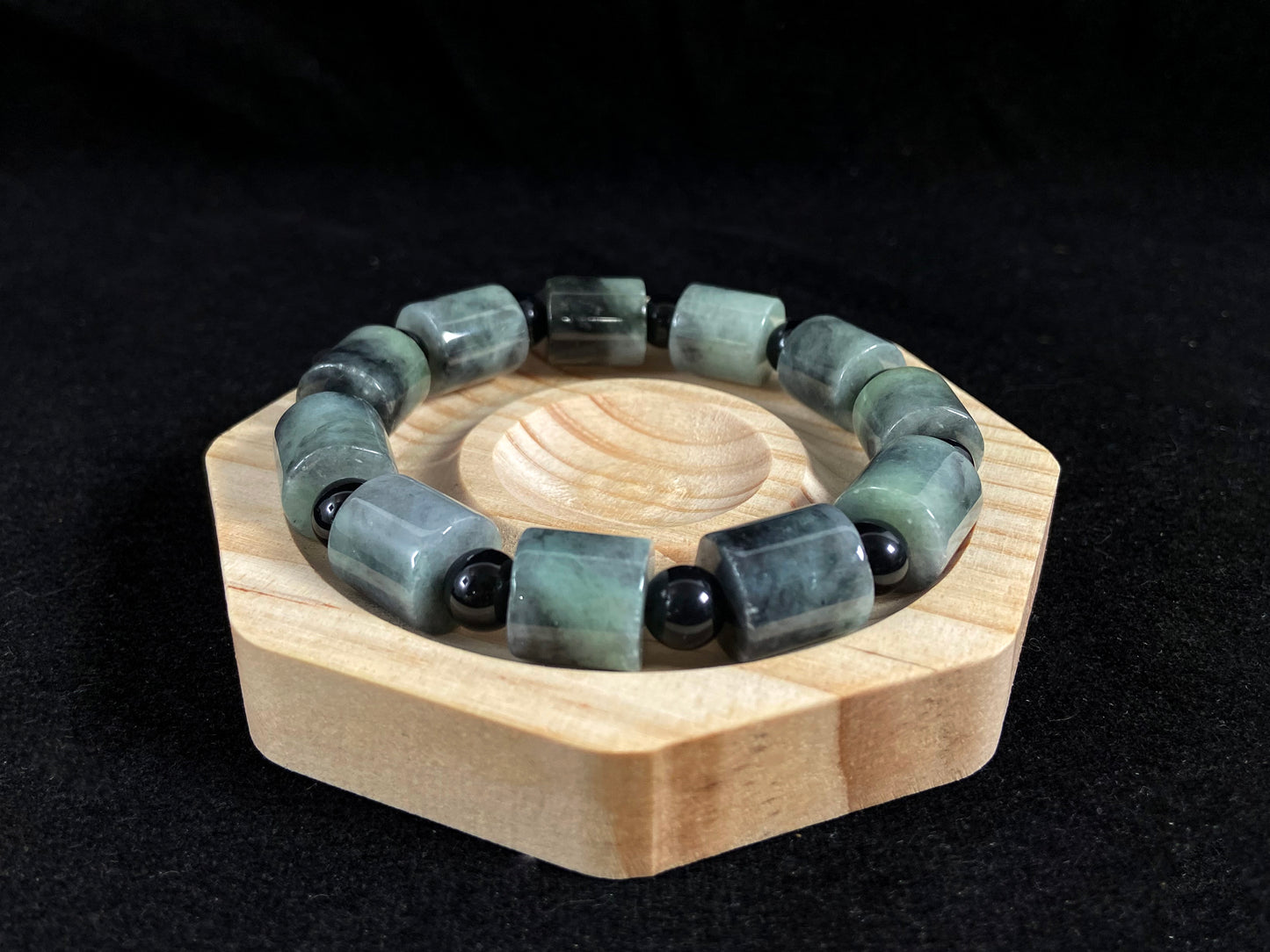 Two black beads combined with a white green black gradient cylinder bead.