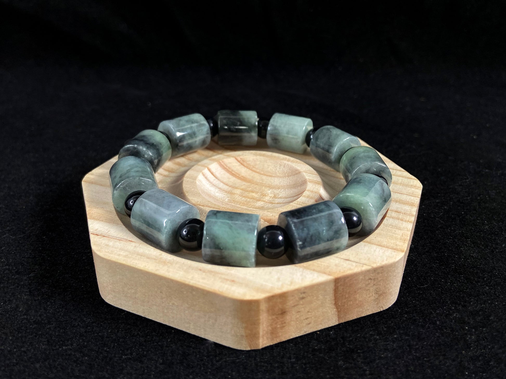 Two black beads combined with a white green black gradient cylinder bead.