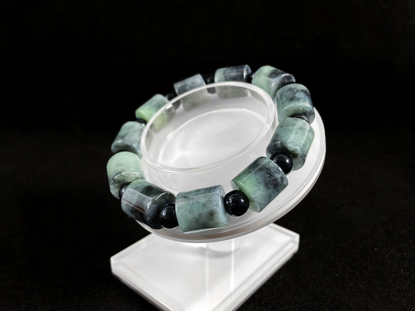 Two black beads combined with a white green black gradient cylinder bead.