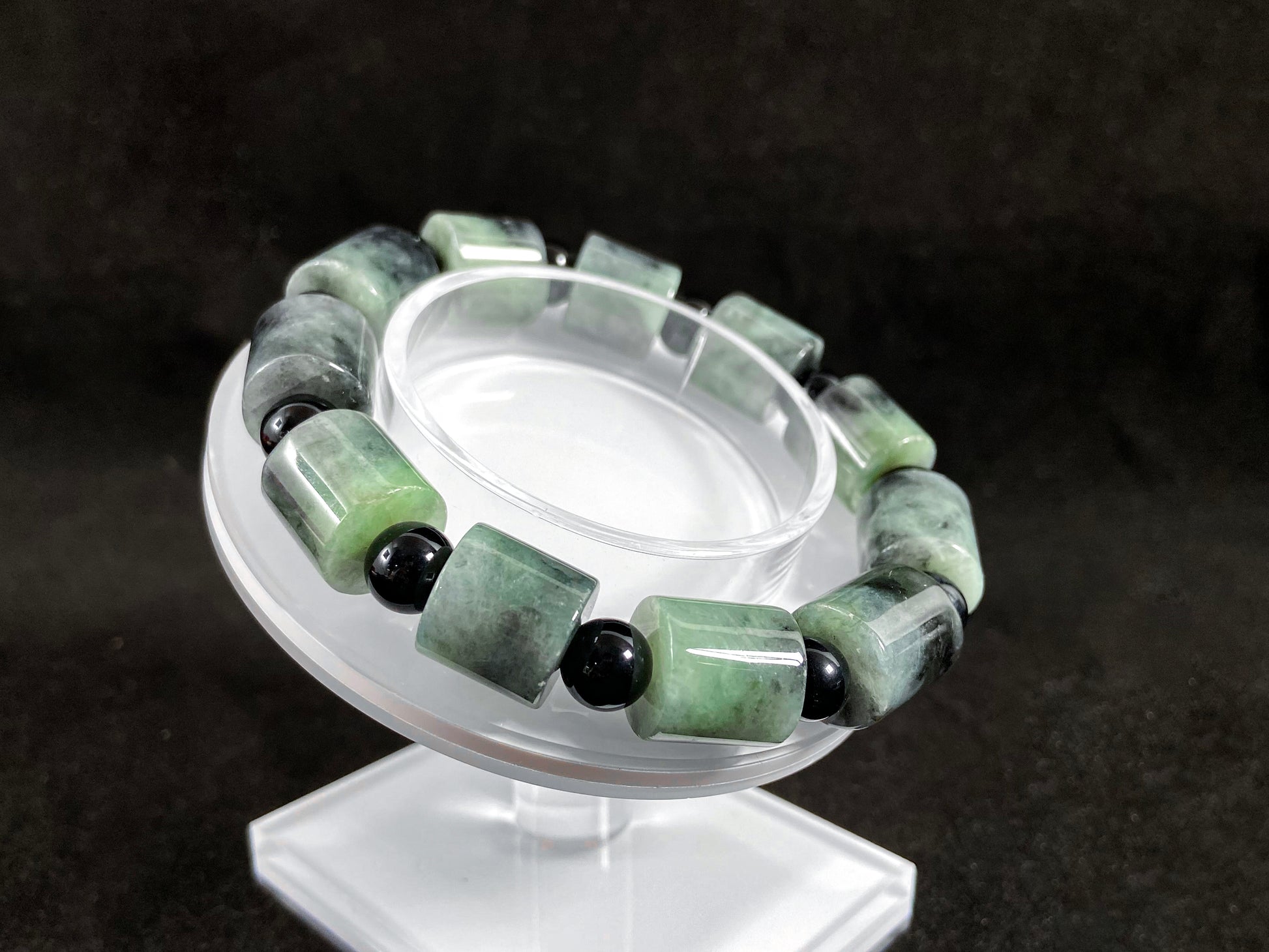 Two black beads combined with a white green black gradient cylinder bead.