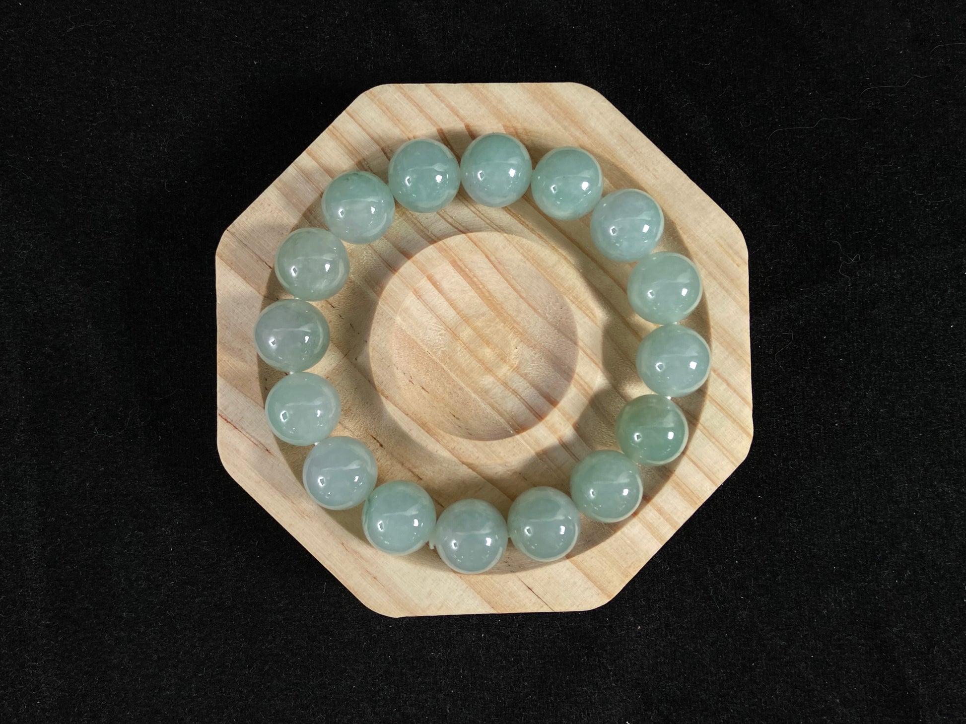 A strand of uniform pale green jade beads.