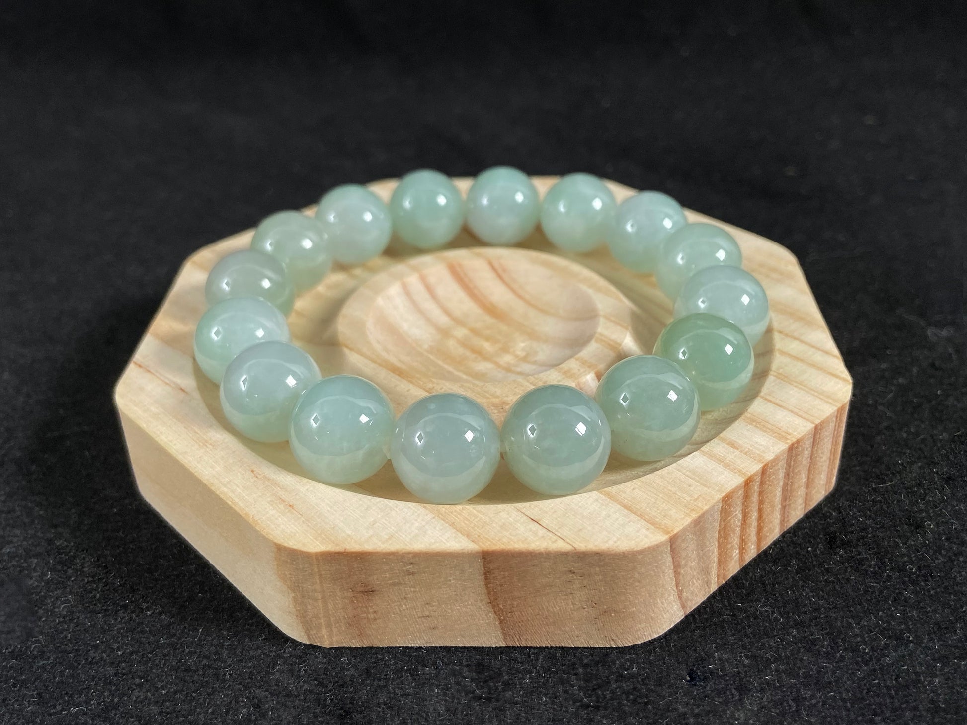 A strand of uniform pale green jade beads.