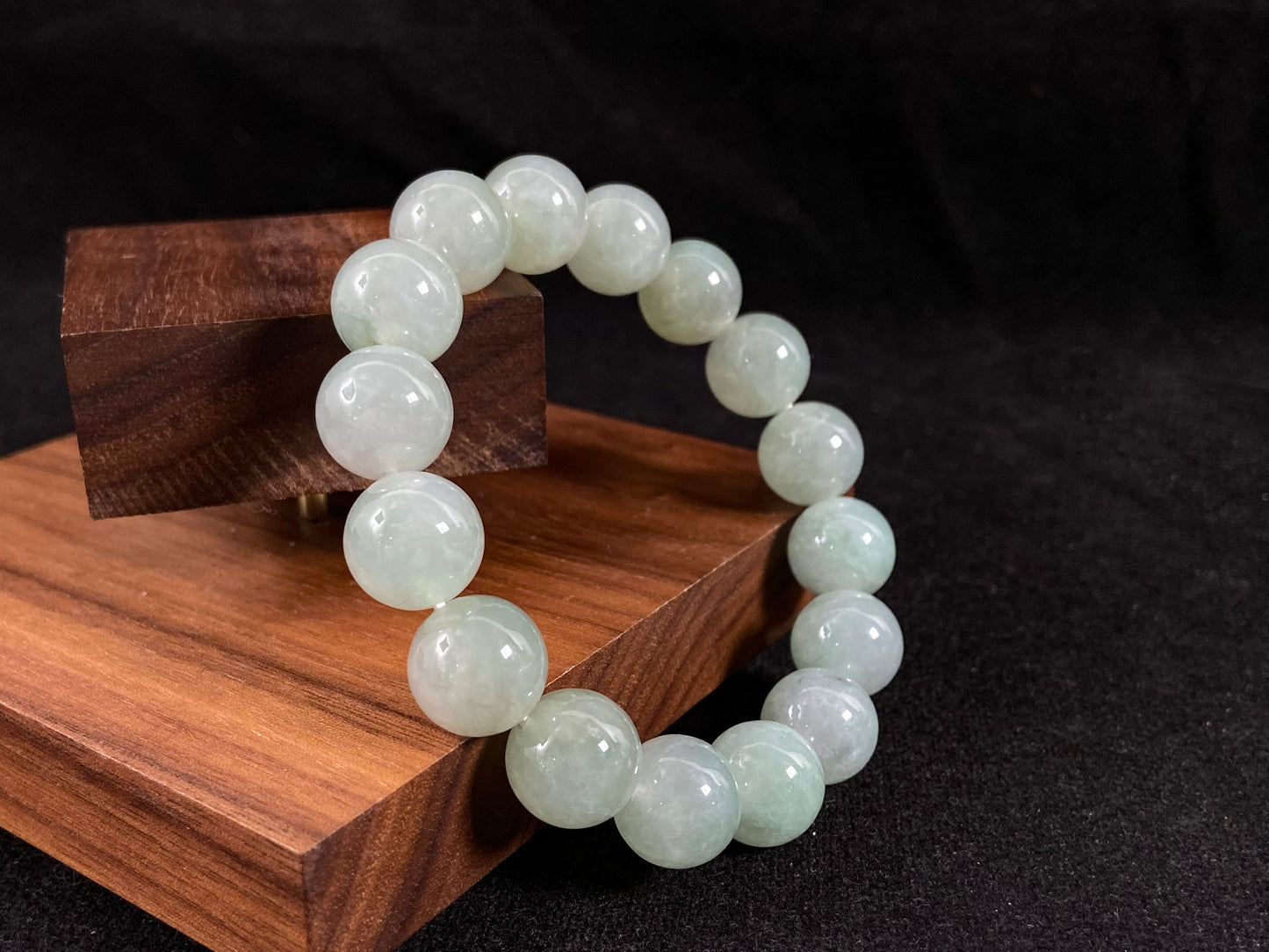 A strand of uniform pale green jade beads.