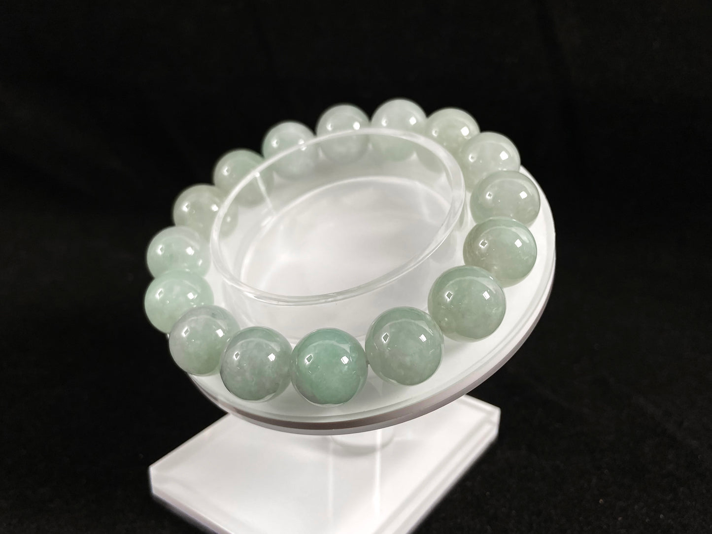 A strand of uniform pale green jade beads.