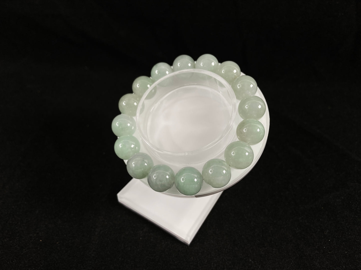 A strand of uniform pale green jade beads.