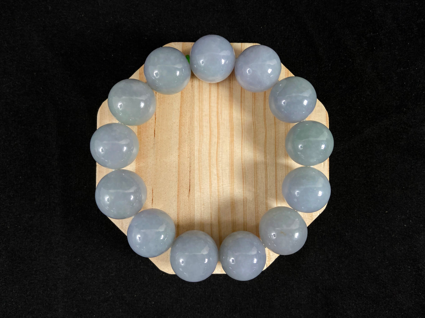 This jade bead strand showcases a natural palette of white based beads with soft lavender hues.
