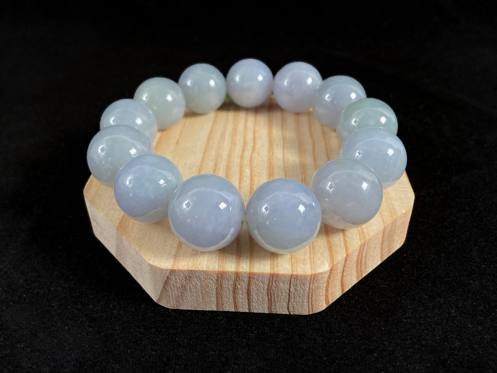 This jade bead strand showcases a natural palette of white based beads with soft lavender hues.