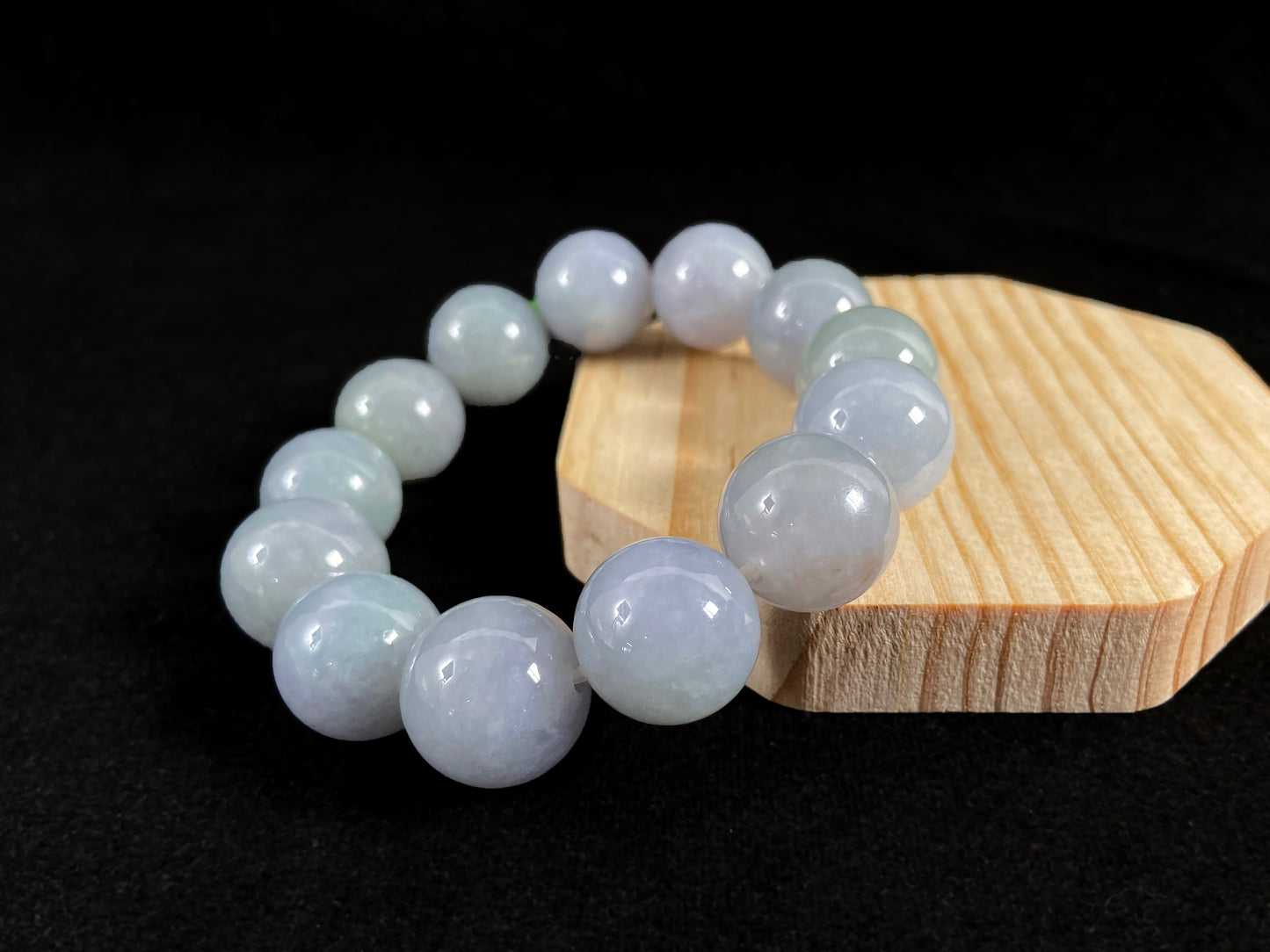 This jade bead strand showcases a natural palette of white based beads with soft lavender hues.