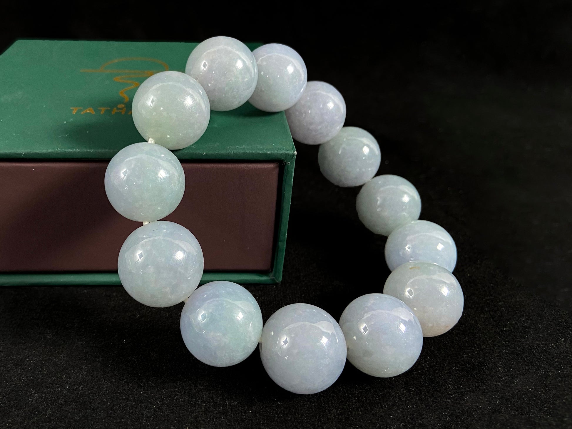 This jade bead strand showcases a natural palette of white based beads with soft lavender hues.