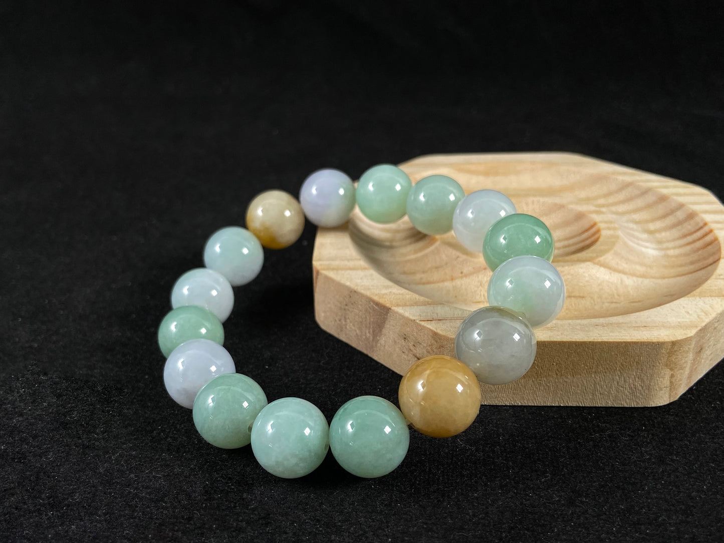 A jade bead strand combining tan, light green, and creamy white tones.