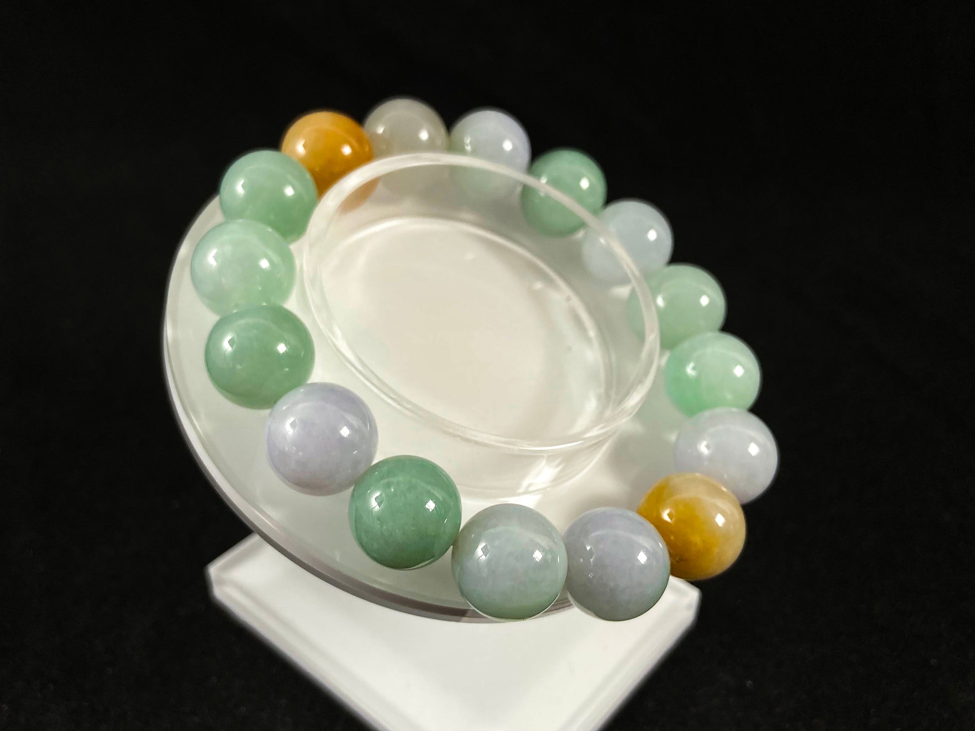 A jade bead strand combining tan, light green, and creamy white tones.