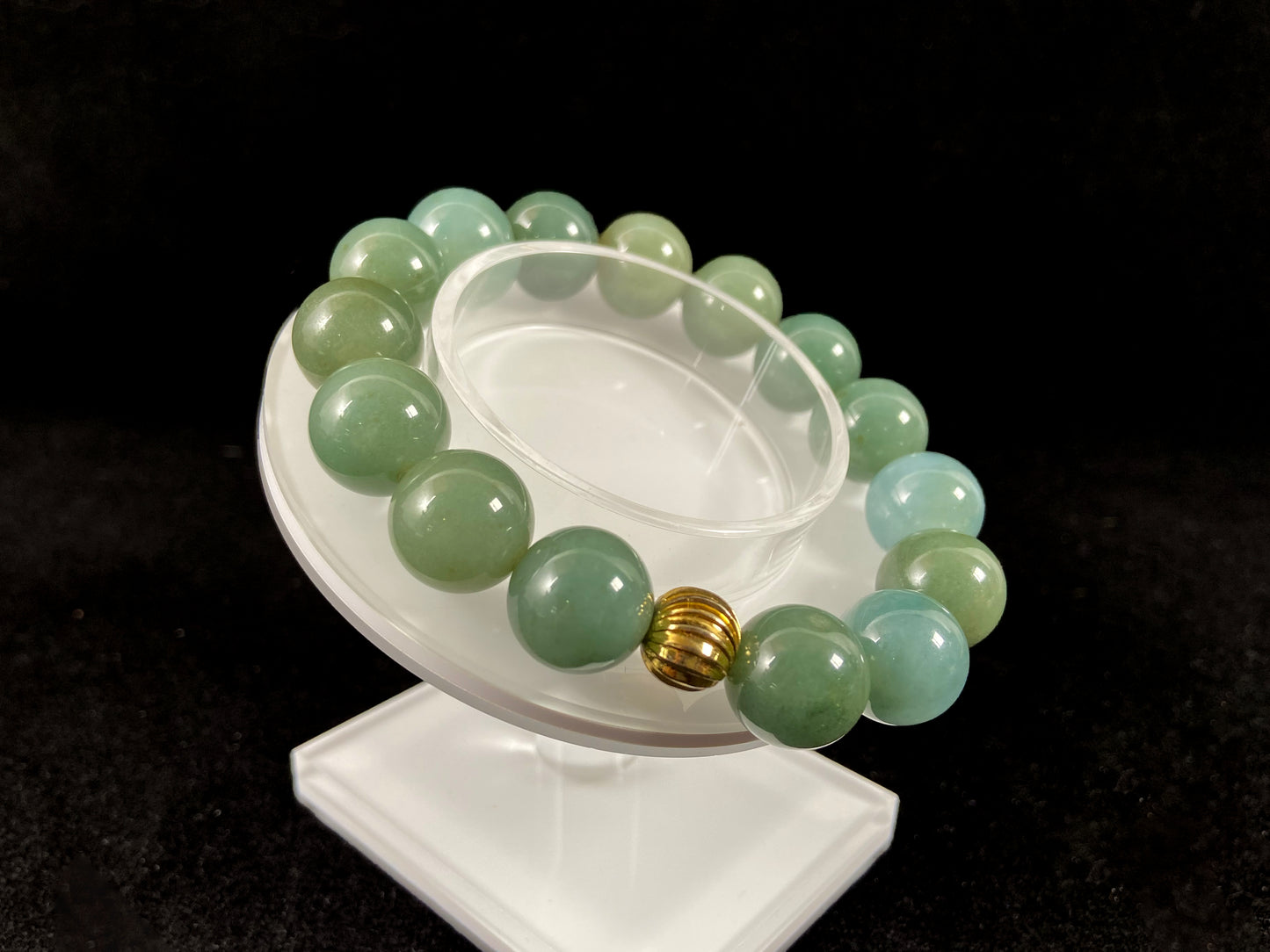 A jade bead strand featuring light blue, deep green, and light green beads with an alloy accent.