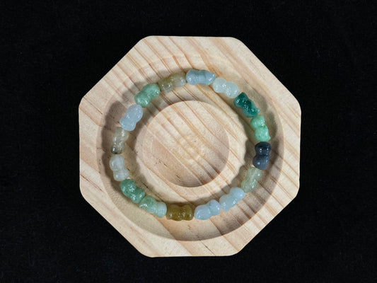 A strand of peanut shaped jade beads in soft yellow, green, brown, grey and ombre white to deep green.