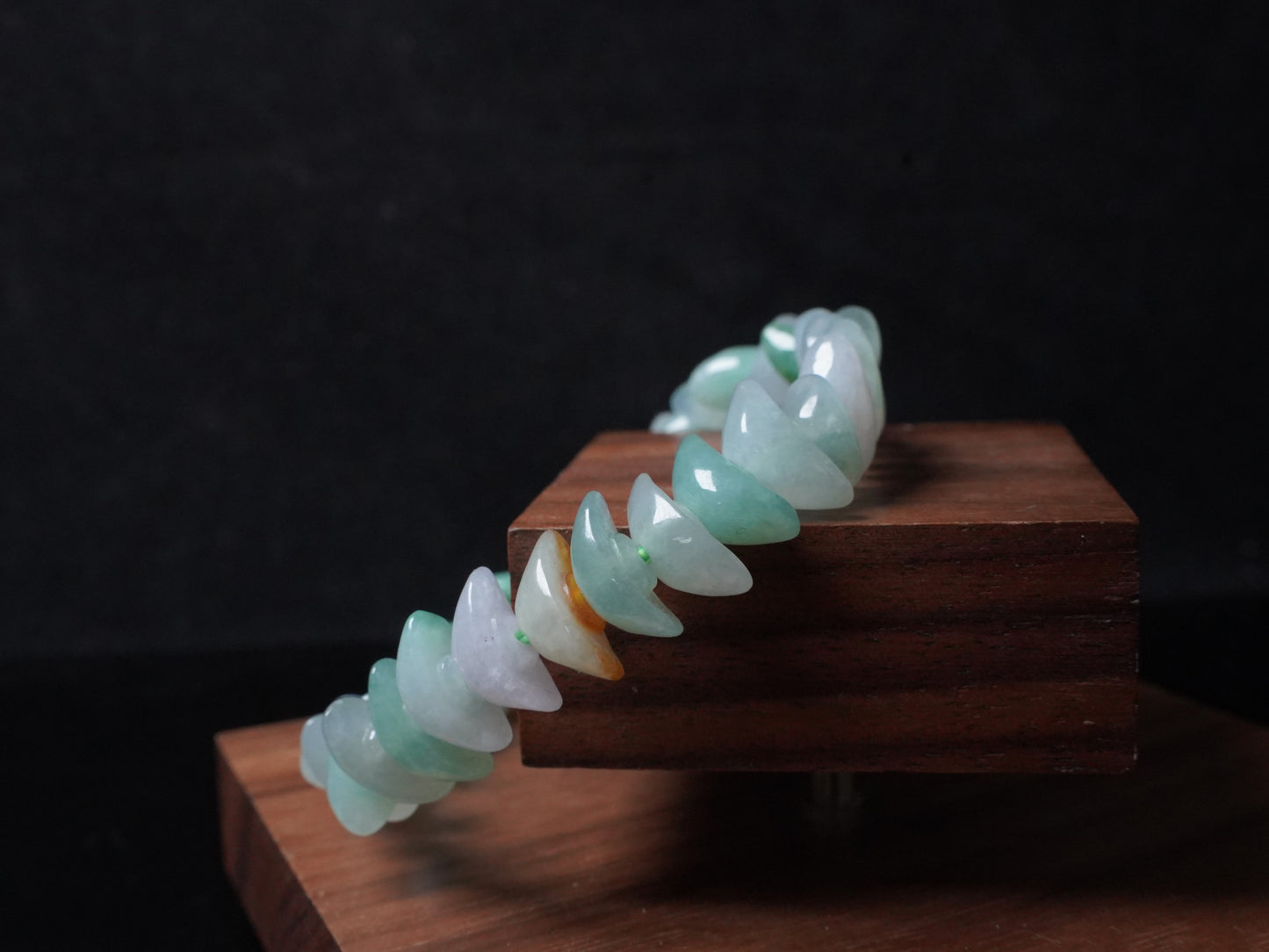 A multi-color Yuanbao-shaped jadeite beads bracelet.
