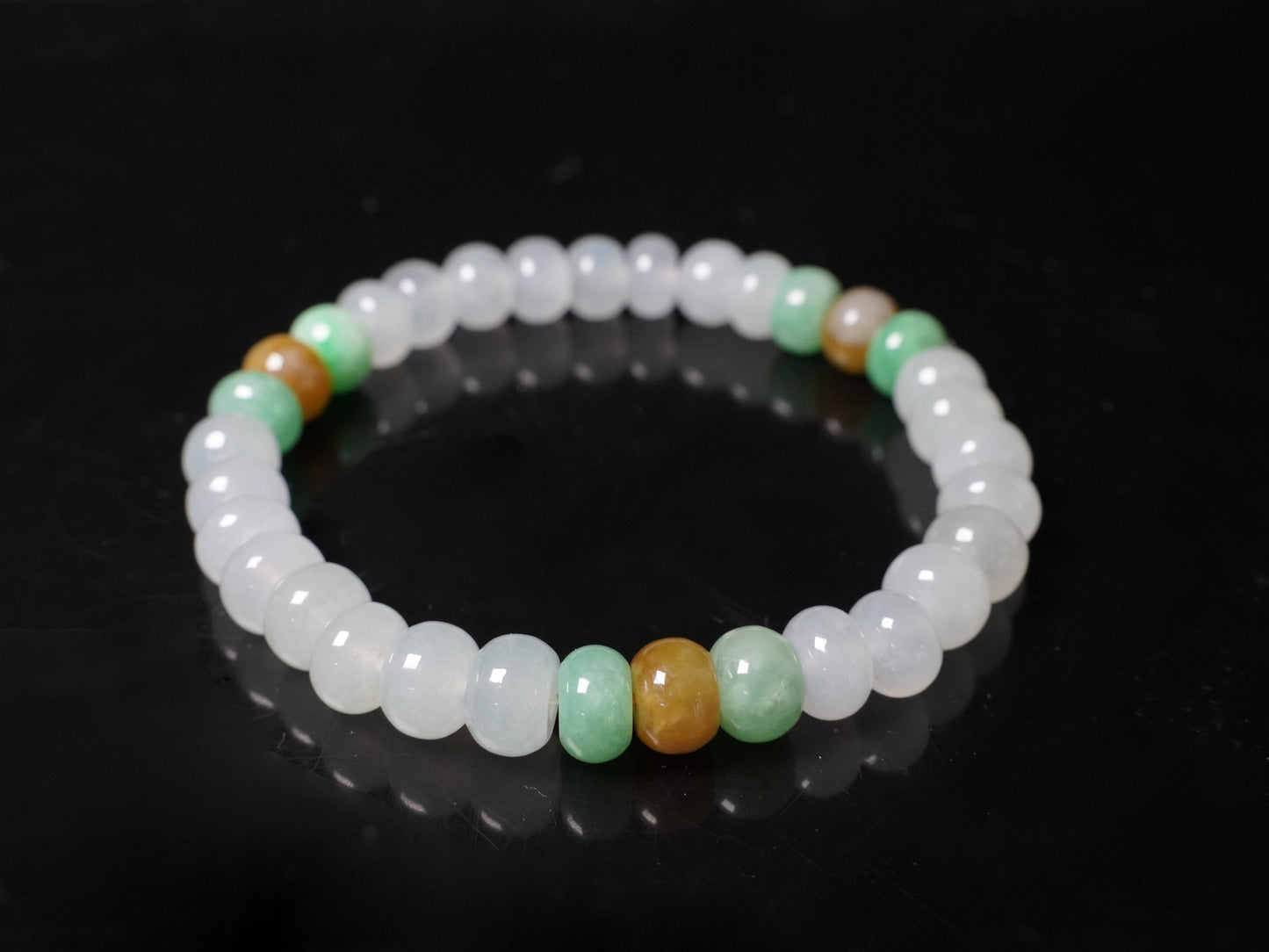 A glacial ice with green and amber accents jadeite beads bracelet.