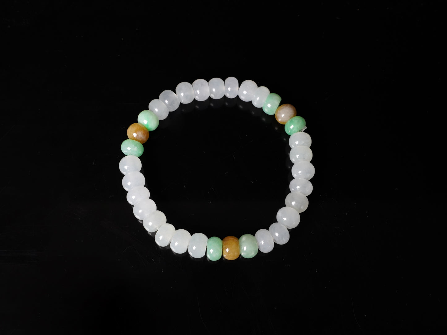A glacial ice with green and amber accents jadeite beads bracelet.