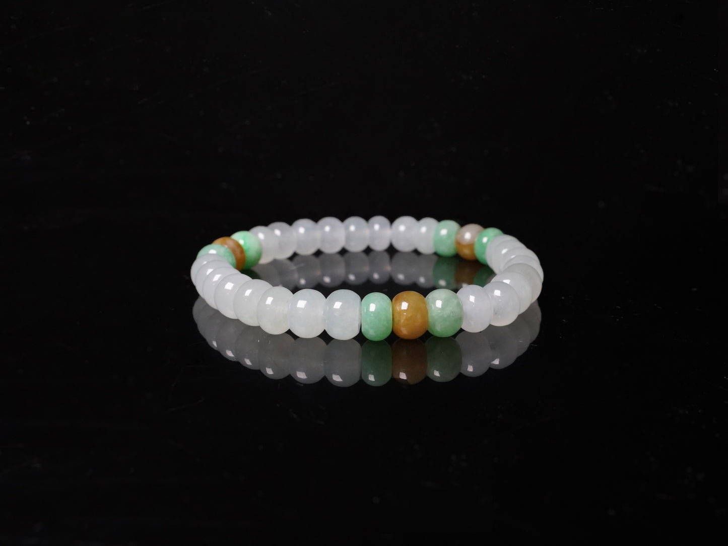 A glacial ice with green and amber accents jadeite beads bracelet.