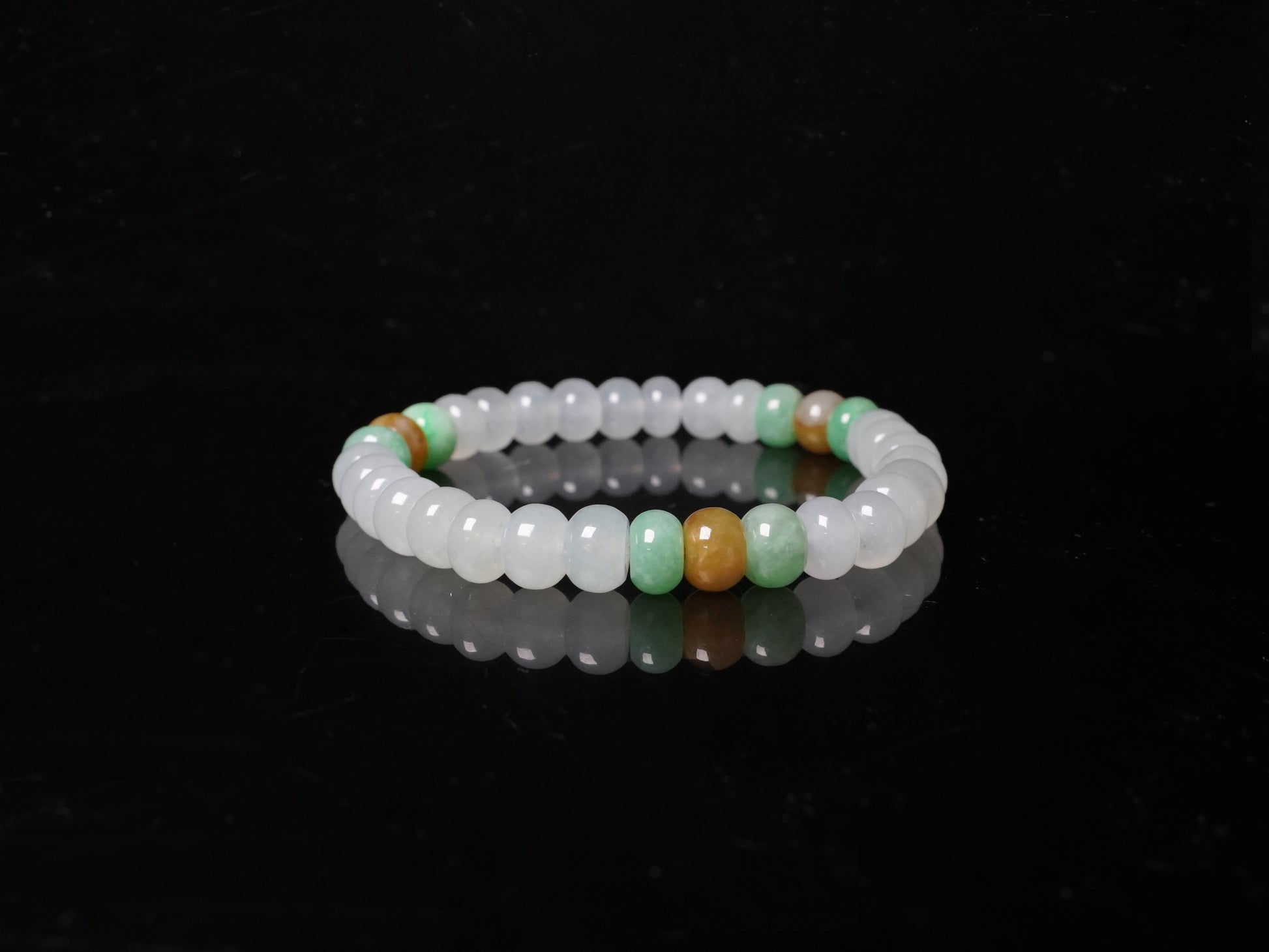 A glacial ice with green and amber accents jadeite beads bracelet.