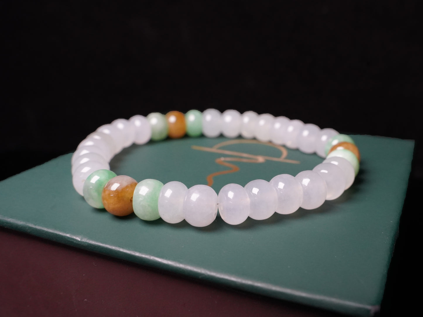 A glacial ice with green and amber accents jadeite beads bracelet.
