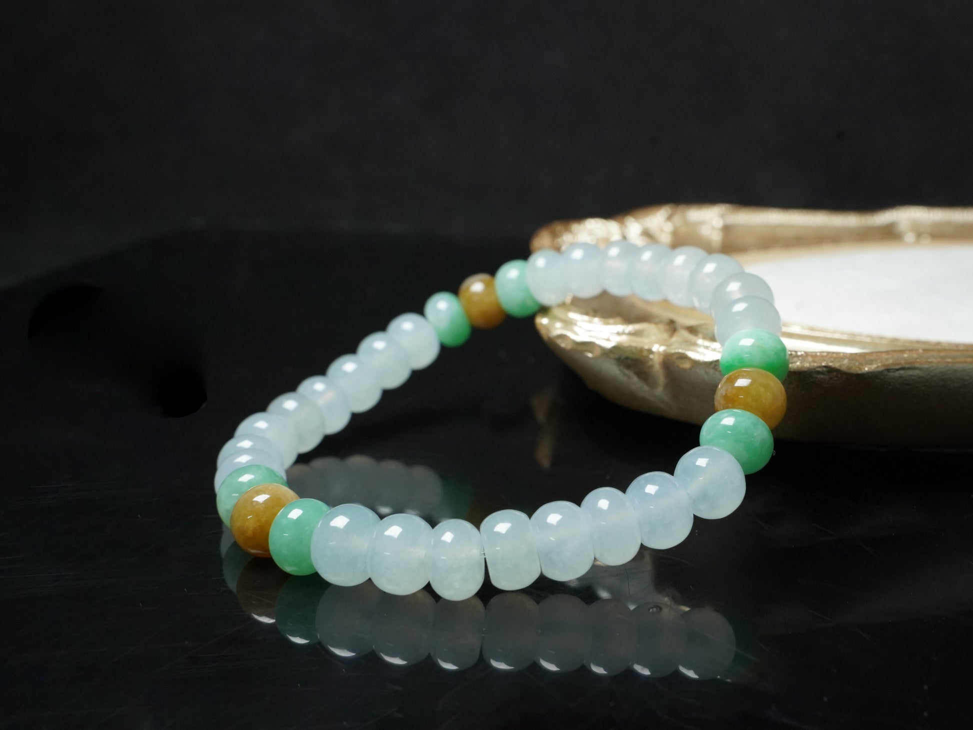 A glacial ice with green and amber accents jadeite beads bracelet.