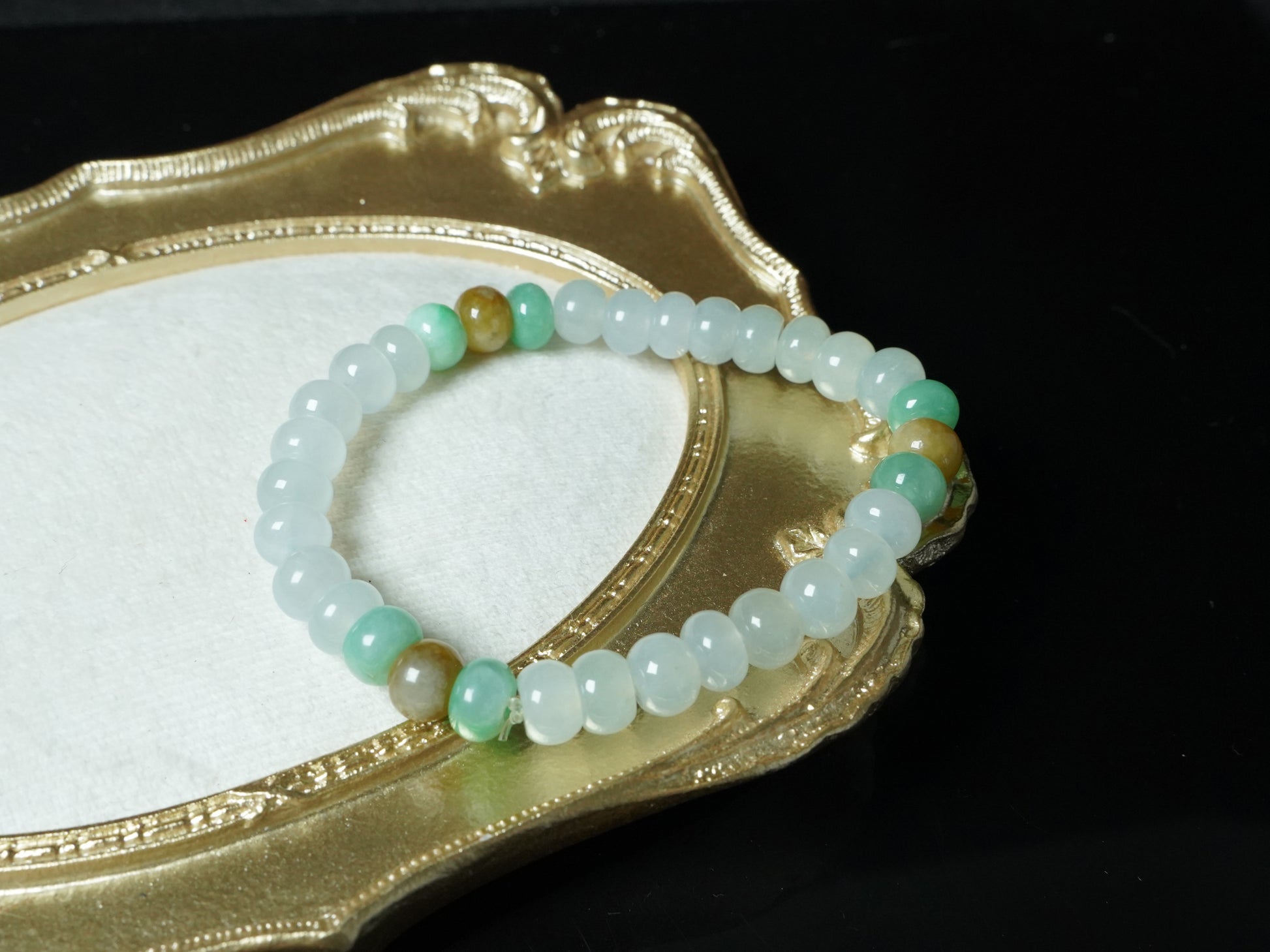 A glacial ice with green and amber accents jadeite beads bracelet.
