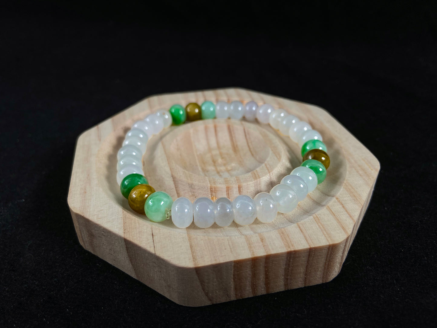 Crystalline jadeite jade beads with verdant and caramel hues.