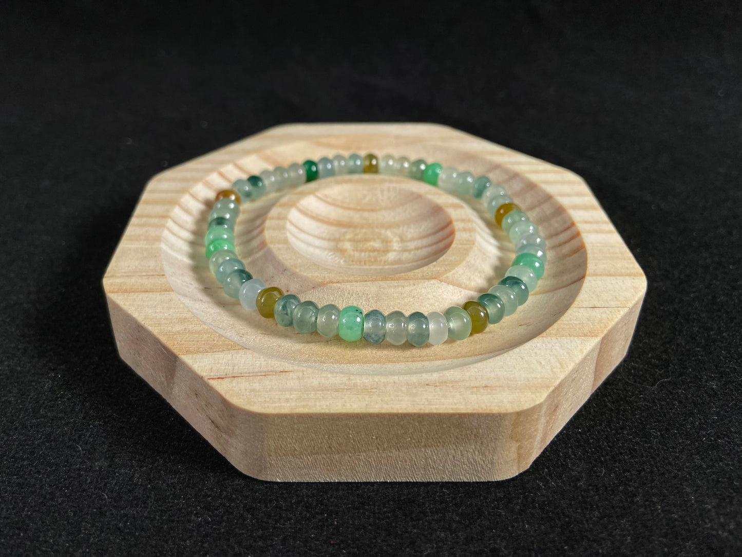 This jadeite bead strand features all transparent beads, including green 
,brown and Icy hues.
