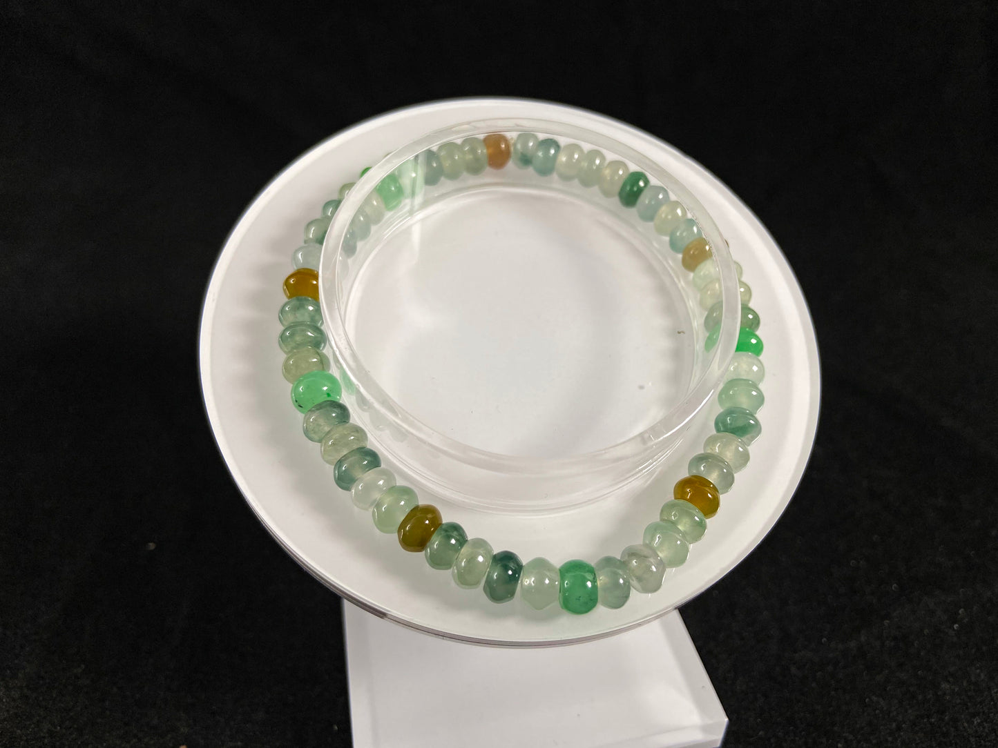 This jadeite bead strand features all transparent beads, including green 
,brown and Icy hues.
