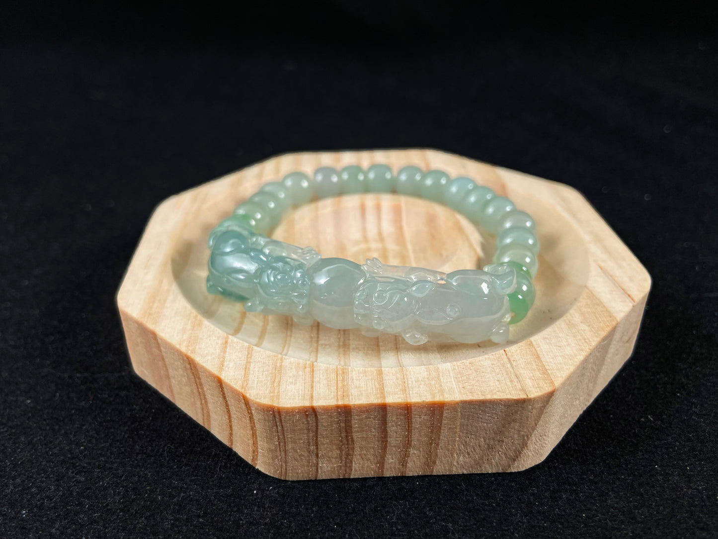 A light green translucent jade bead bracelet featuring two matching Pixiu charms.