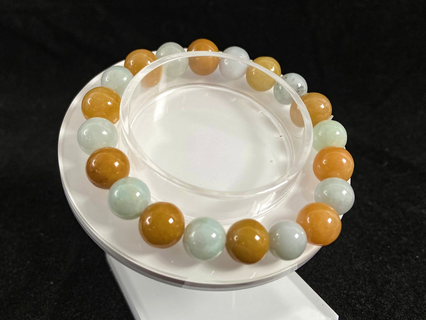 A jade bead strand with alternating creamy white and yellow/brown beads.