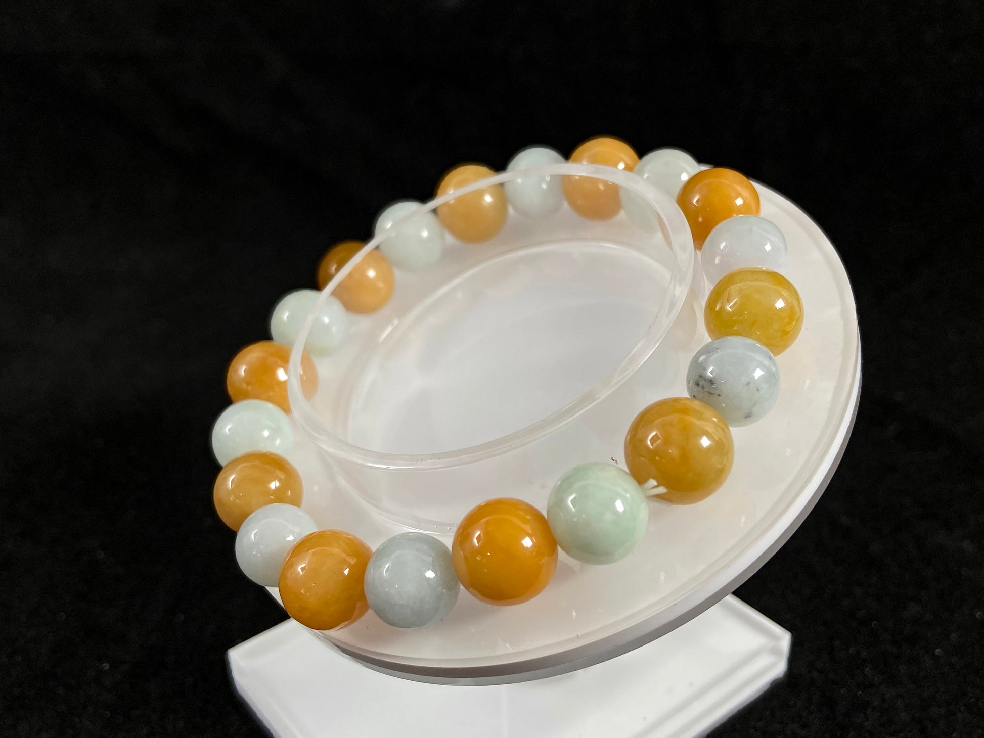 A jade bead strand with alternating creamy white and yellow/brown beads.