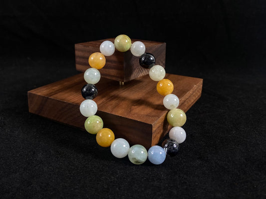 A jade bead strand in earthy brown, pure white, classic black, and ethereal blue-white.