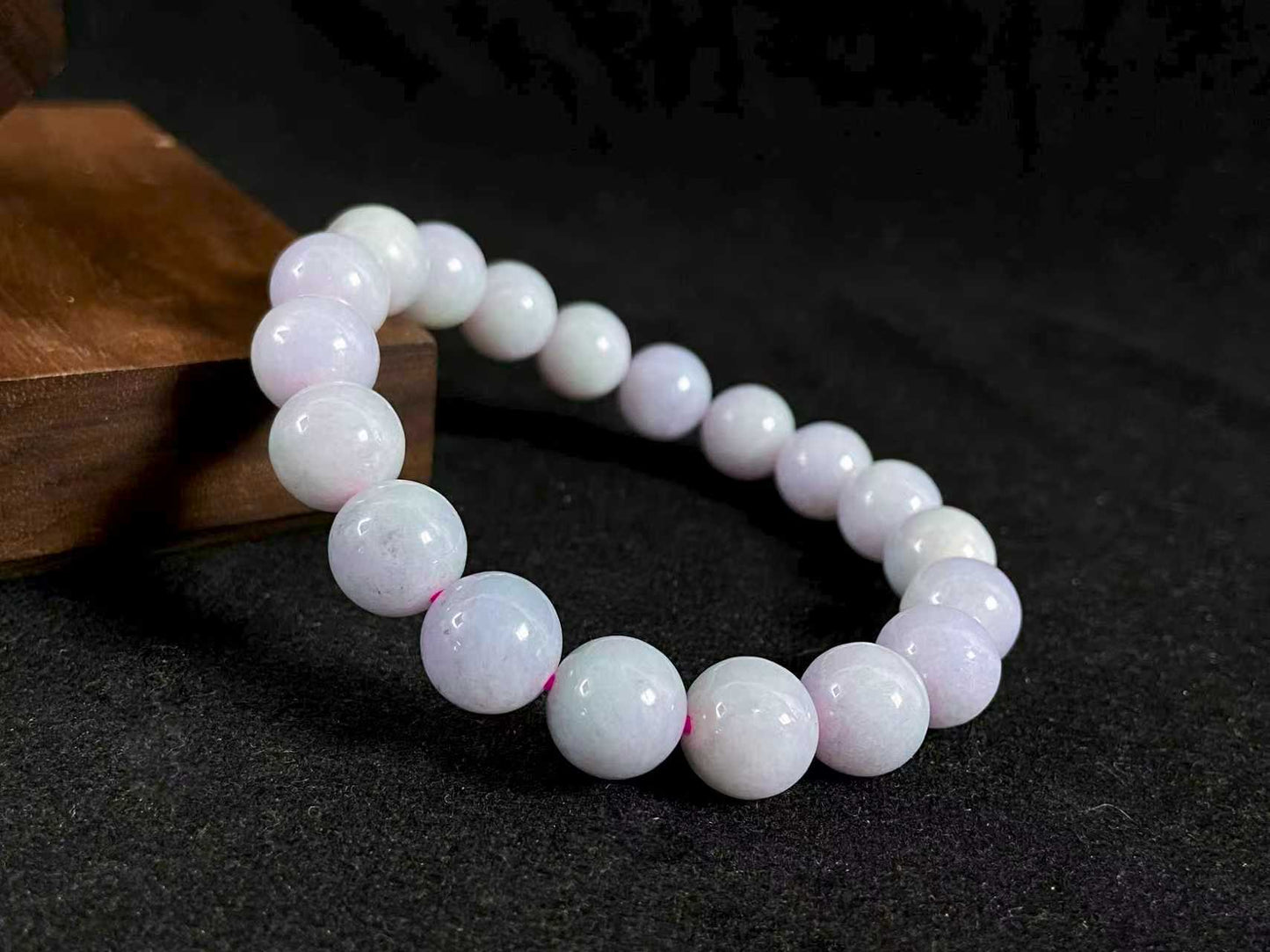 A jade bead strand in a uniform creamy white color.