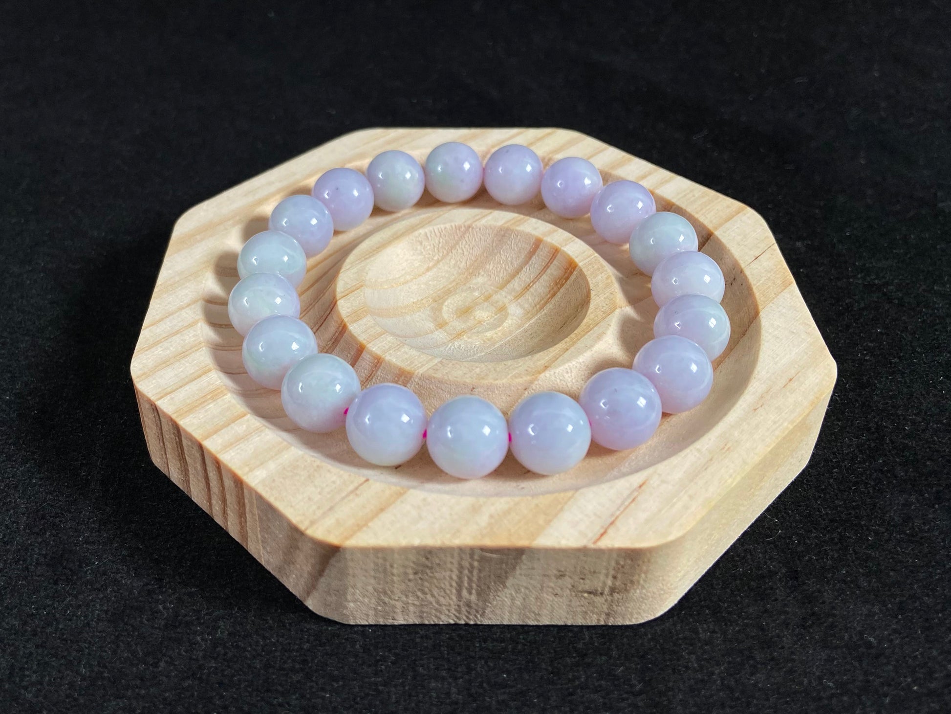 A jade bead strand in a uniform creamy white color.